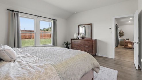 1304 Quest Bridge Road primary bedroom with natural lighting and hardwood floors