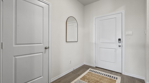 1308 Quest Bridge Road interior entry with white doors and hardwood floors