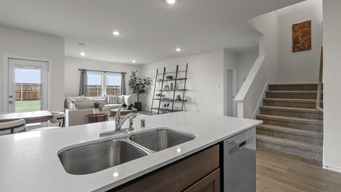 1308 Quest Bridge Road granite kitchen counter with view of living area and staircase