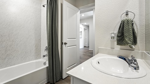 bathroom with a vanity sink, toilet and shower