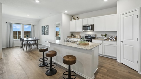 kitchen with white cabinetry, large island and stainless steel appliances