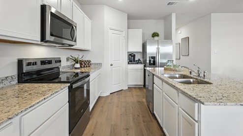 kitchen with white cabinetry, large island and stainless steel appliances