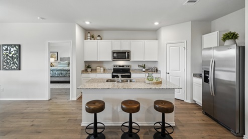 kitchen with white cabinetry, large island and stainless steel appliances