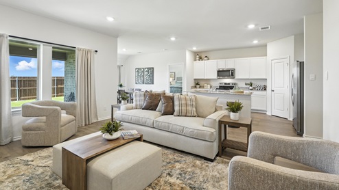 cozy living room with a grey sofa and beige accent chairs