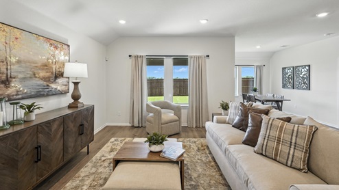 cozy living room with a grey sofa and beige accent chairs