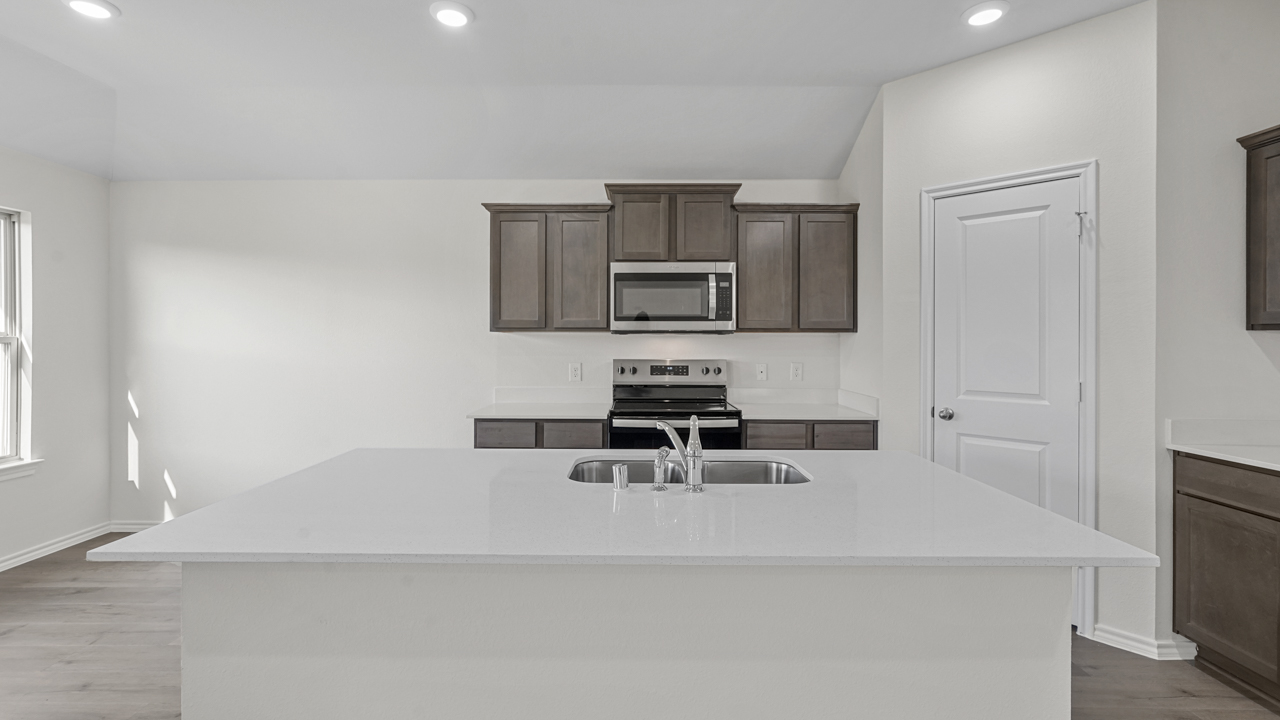 Kitchen with brown cabinets and white countertops