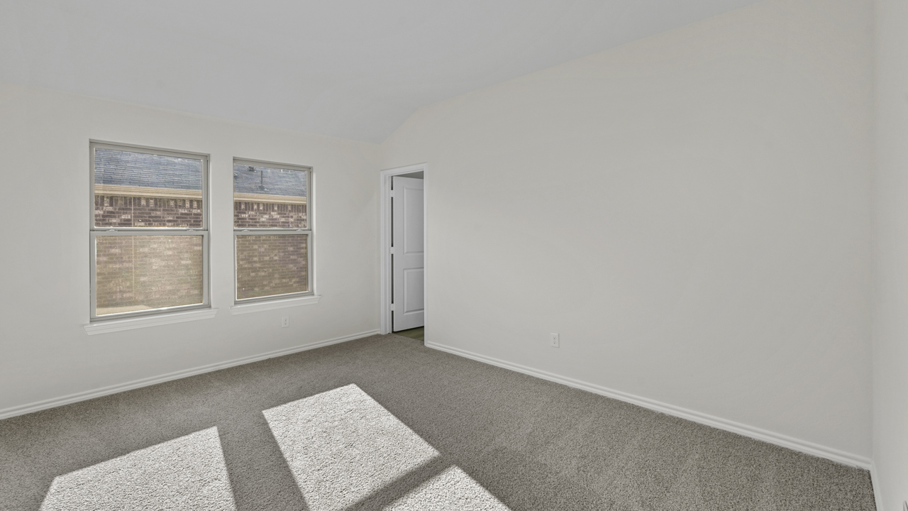 large primary bedroom with double window