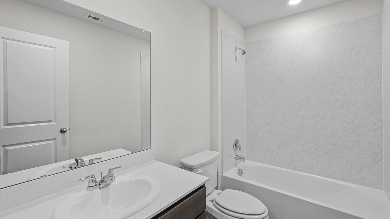 secondary bathroom with vanity and garden tub