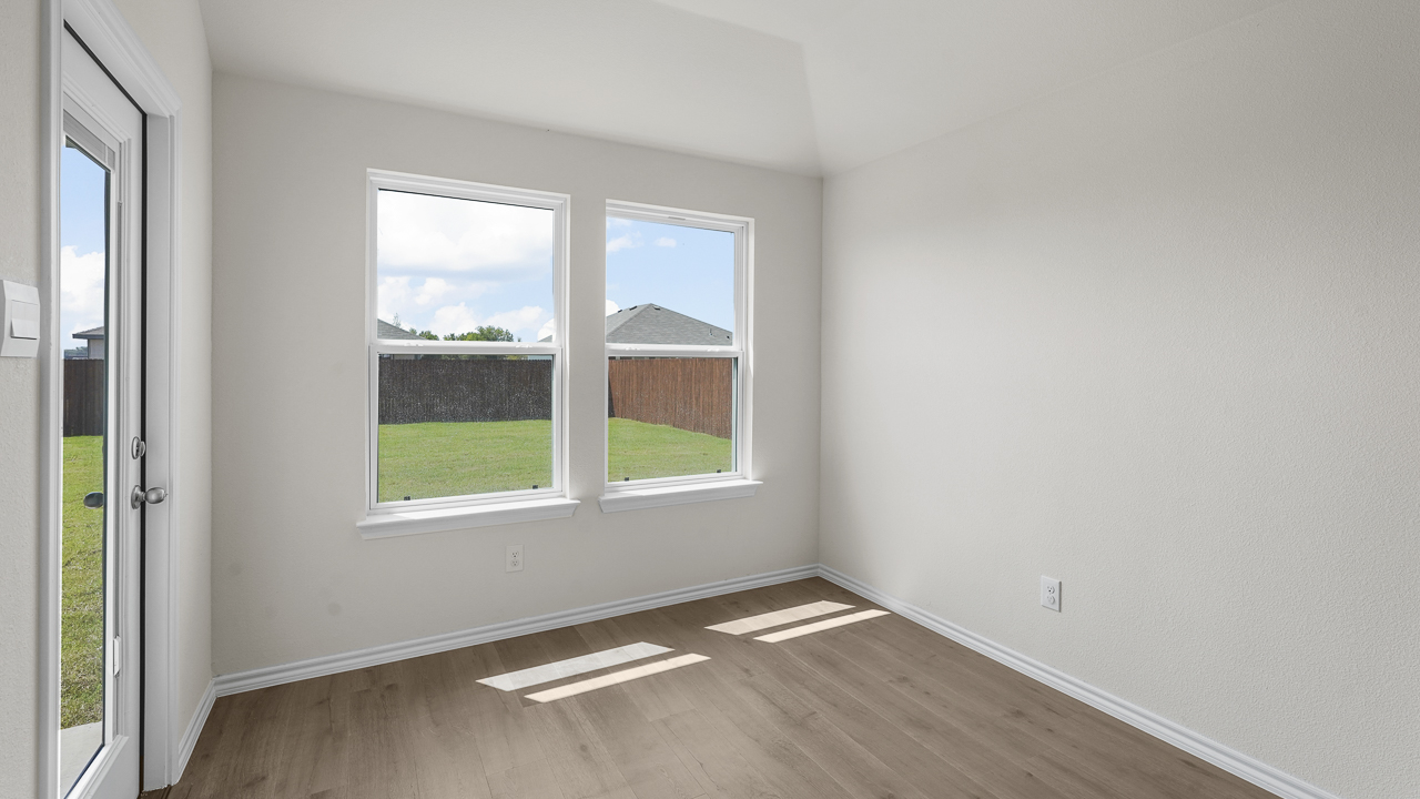 breakfast nook area with back door and large double windows
