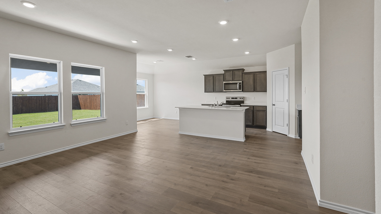 view of kitchen from living room with large double windows