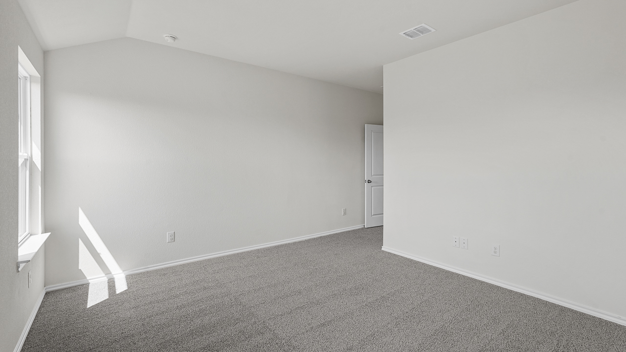 large primary bedroom with two windows