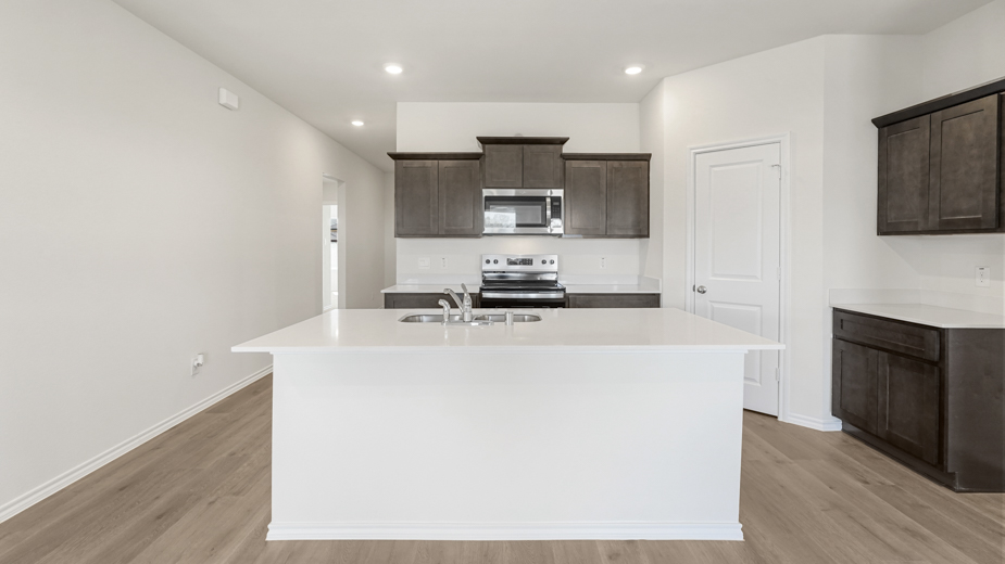 kitchen with large island and brown cabinets