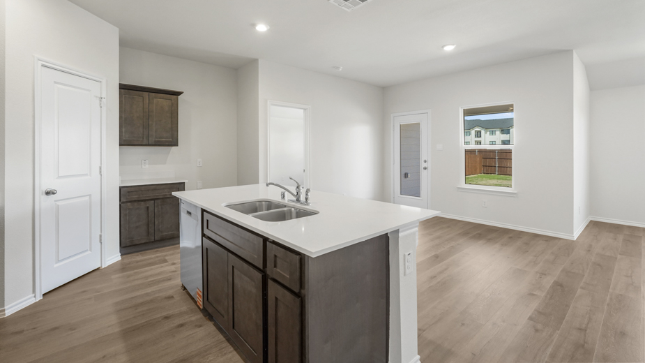 kitchen island with sink overlooking breakfast nook