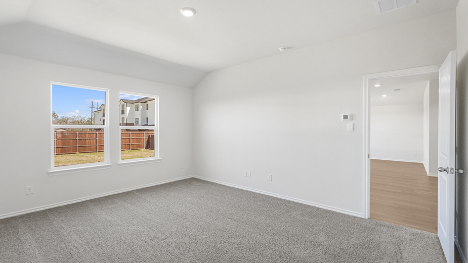 large primary bedroom with two large windows