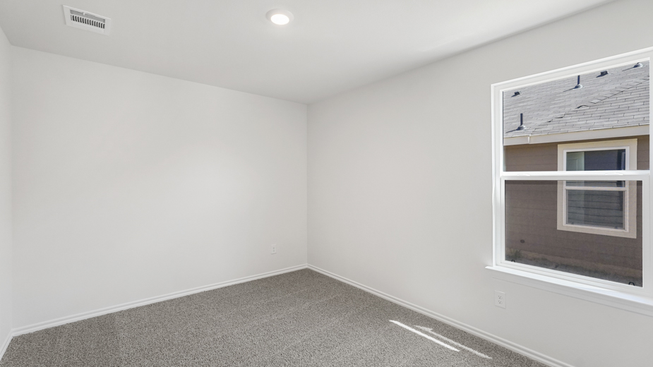 secondary bedroom with window and closet