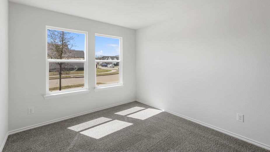 secondary bedroom with double window and closet