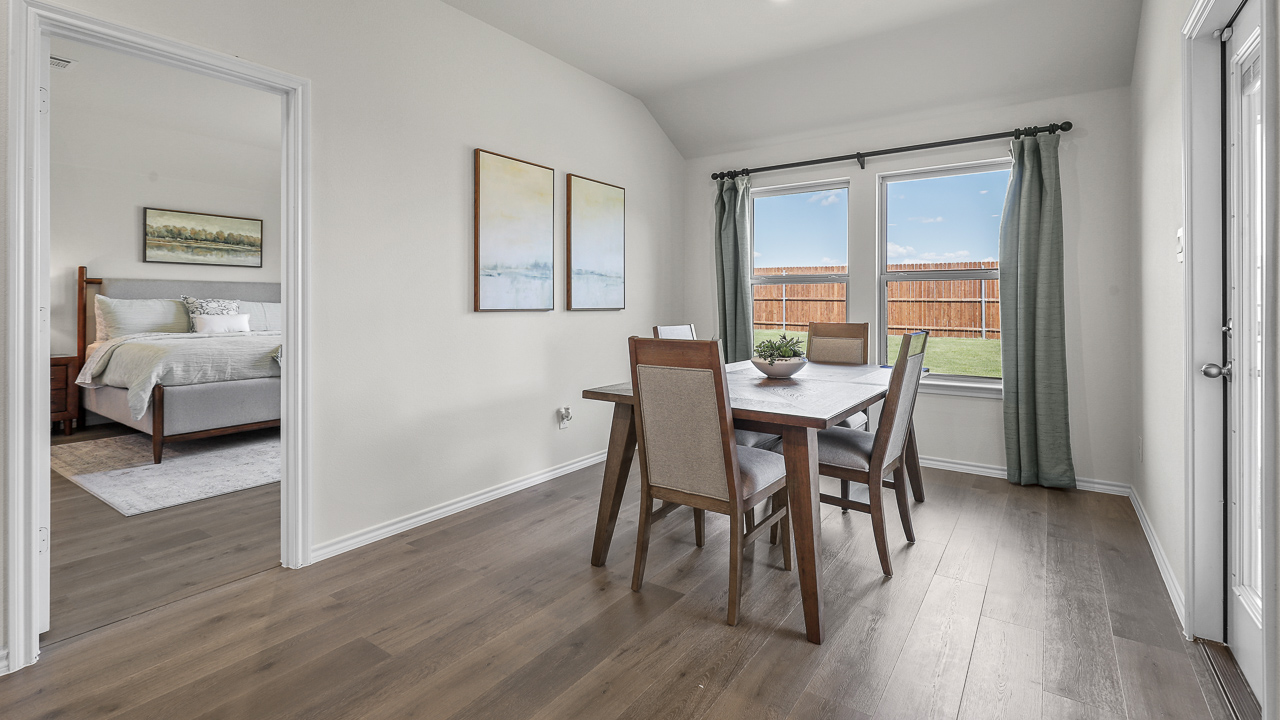 breakfast nook with large windows and table with chairs