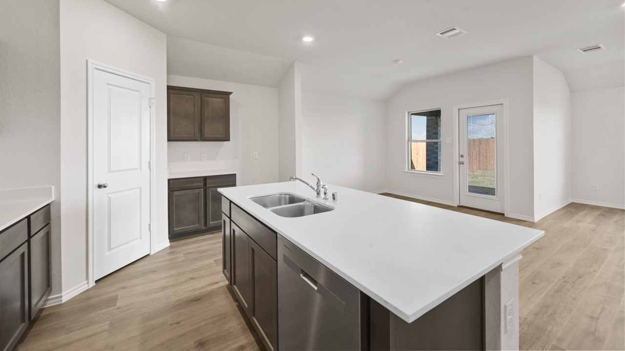 kitchen with island with white countertops and sink