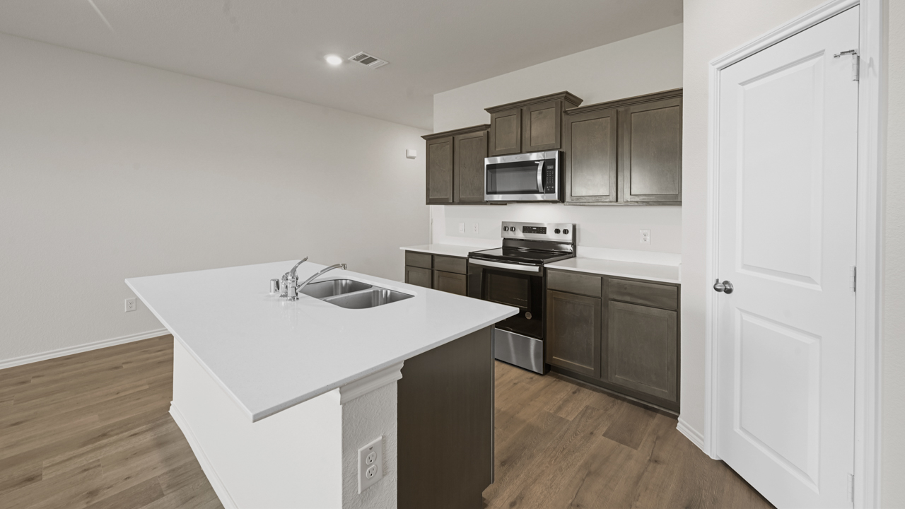 kitchen island with white countertop and brown cabinets
