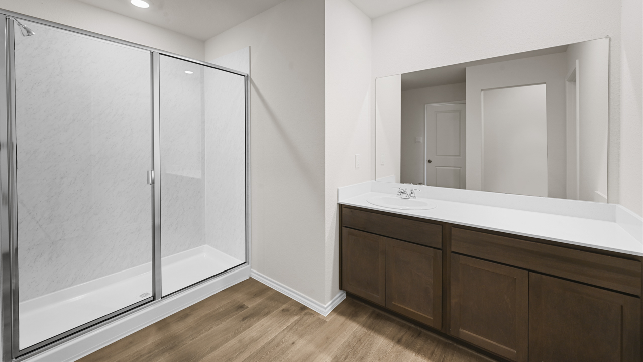 primary bathroom with walk in shower and elongated vanity
