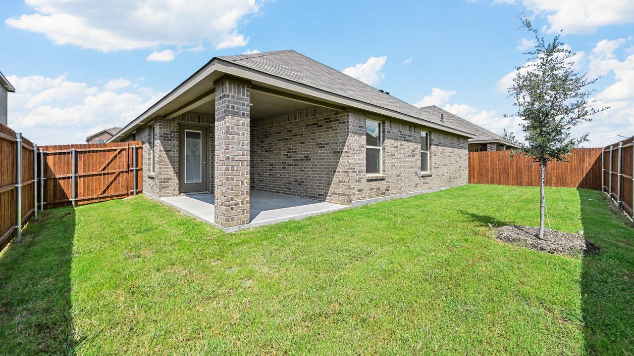 back view of single story home with large covered patio