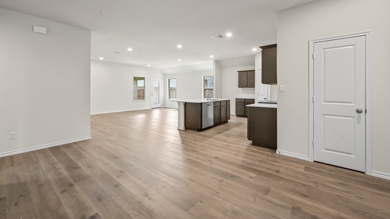 open concept view of kitchen and living area from entry