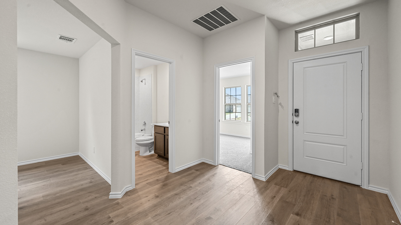 close up of front entry and three doors to bathroom office and bedroom