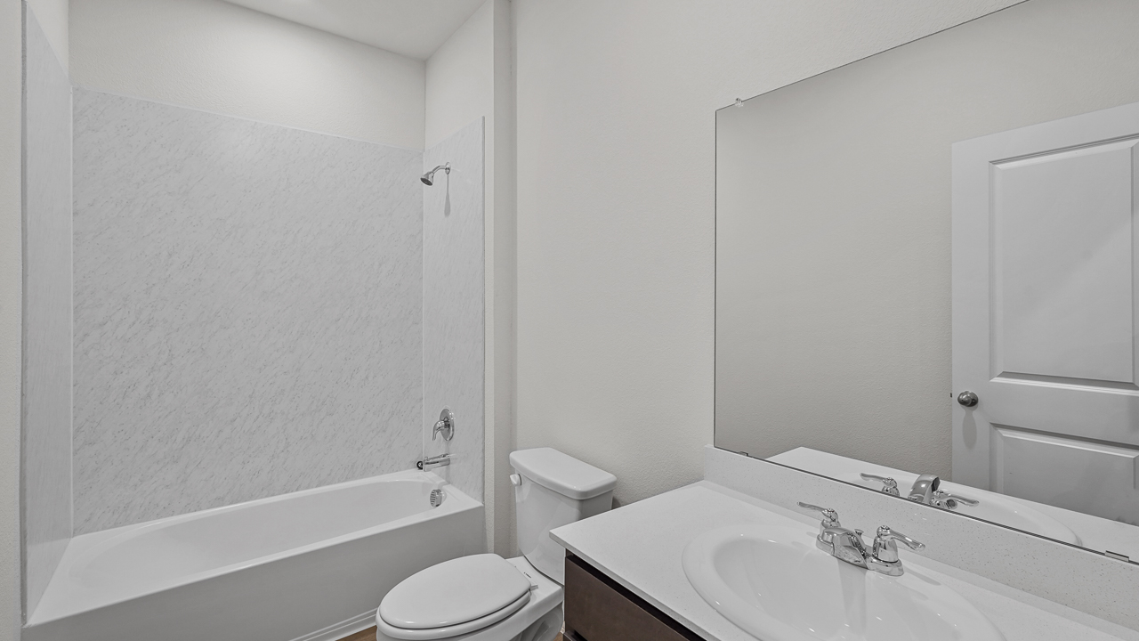 secondary bathroom with vanity and garden tub