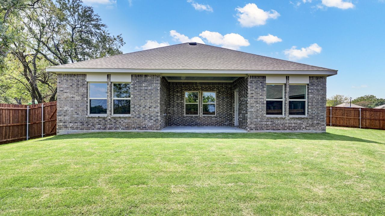 exterior of two story gray brick home and covered patio