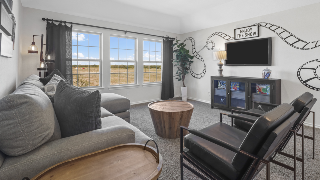media room with large windows and movie themed furniture