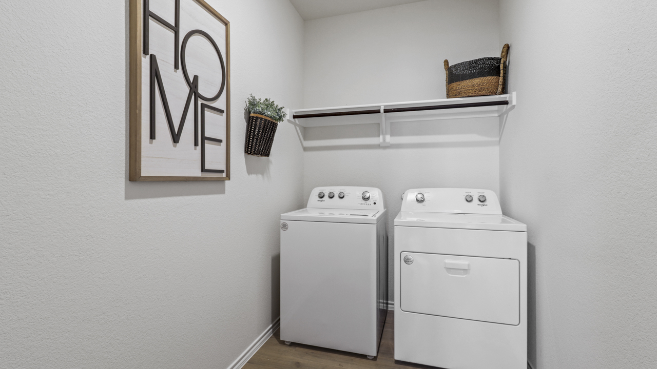 utility room with hanging rod and shelf with washer and dryer