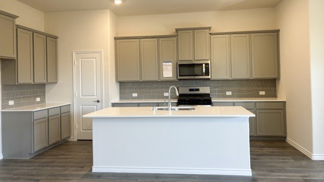 kitchen area with hardwood floors white counters and grey cabinets