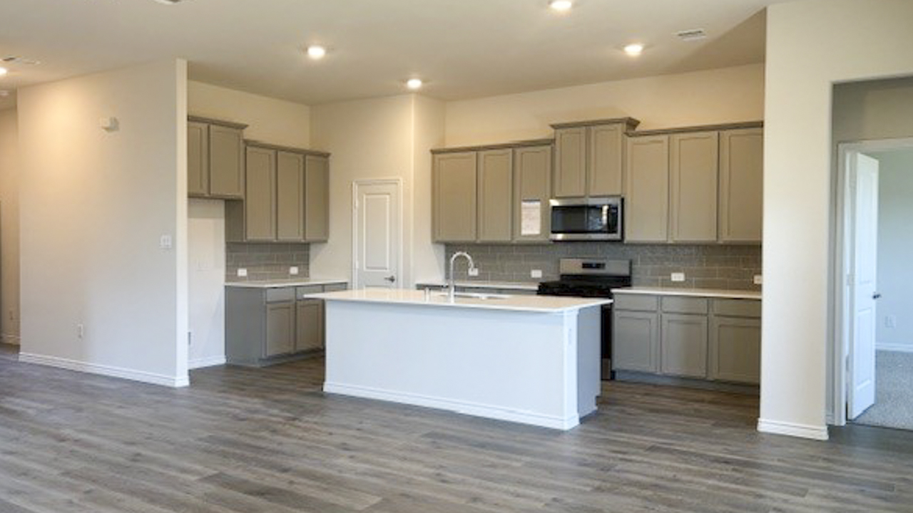 kitchen area with hardwood floors white counters and grey cabinets