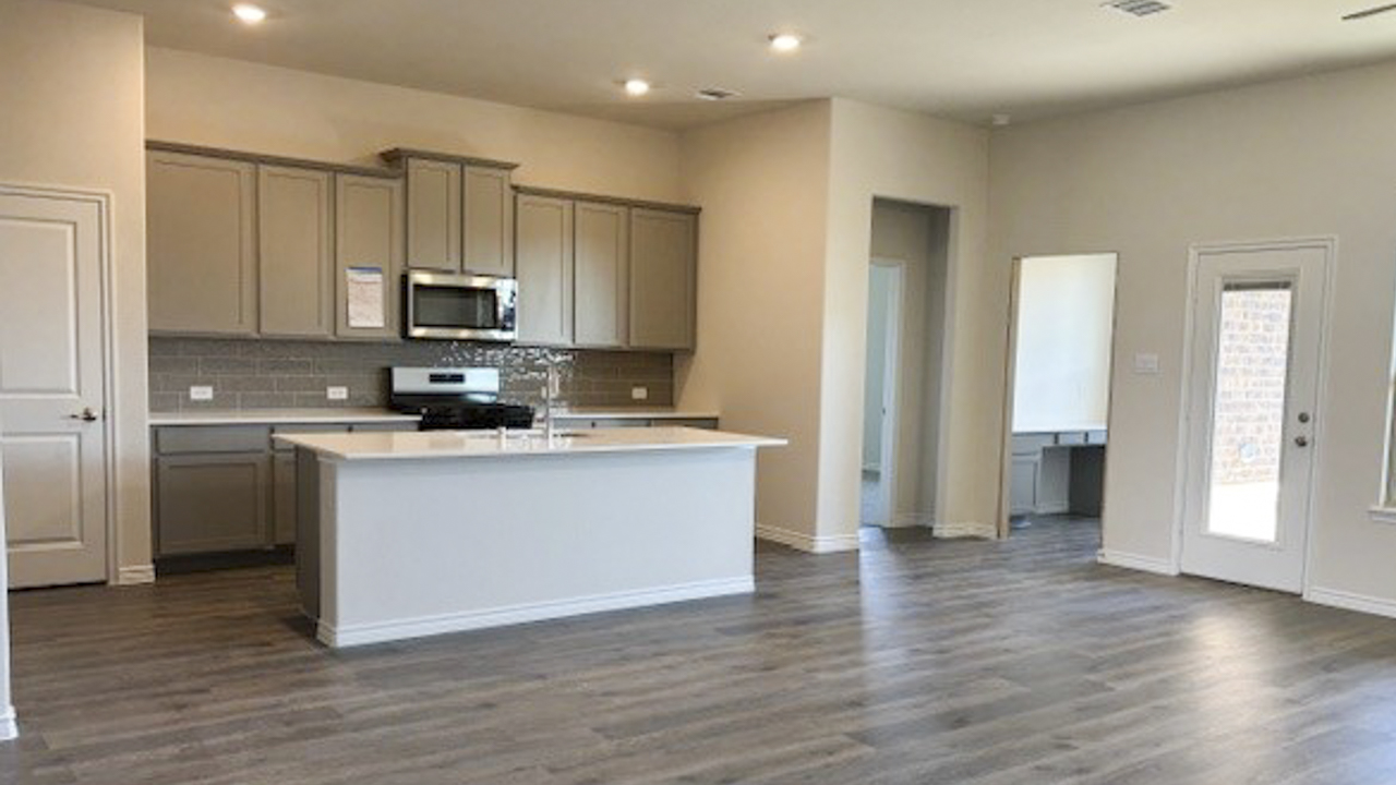kitchen area with hardwood floors white counters and grey cabinets