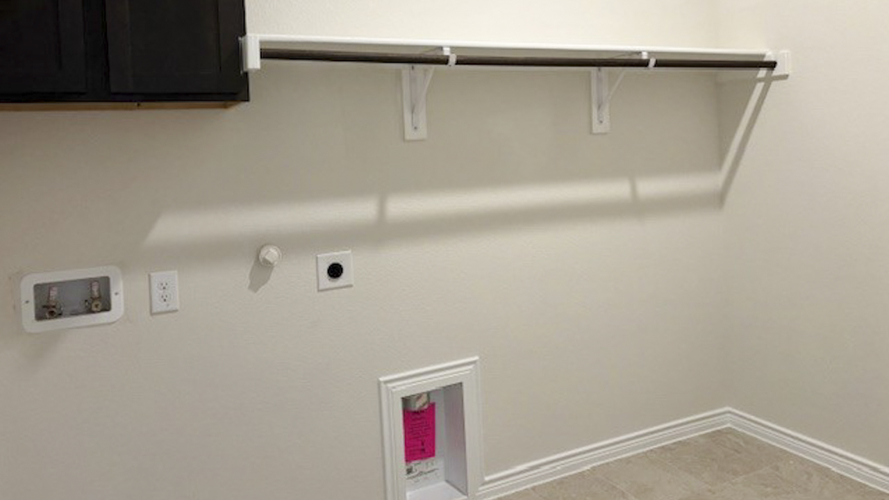 utility area with tile for washer and dryer