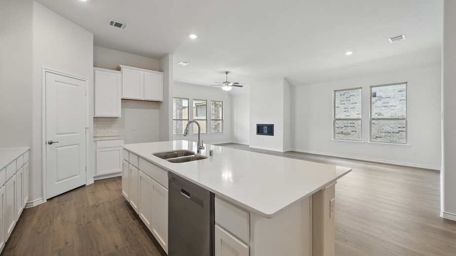 kitchen area with hardwood floors and light colored cabinets and counters