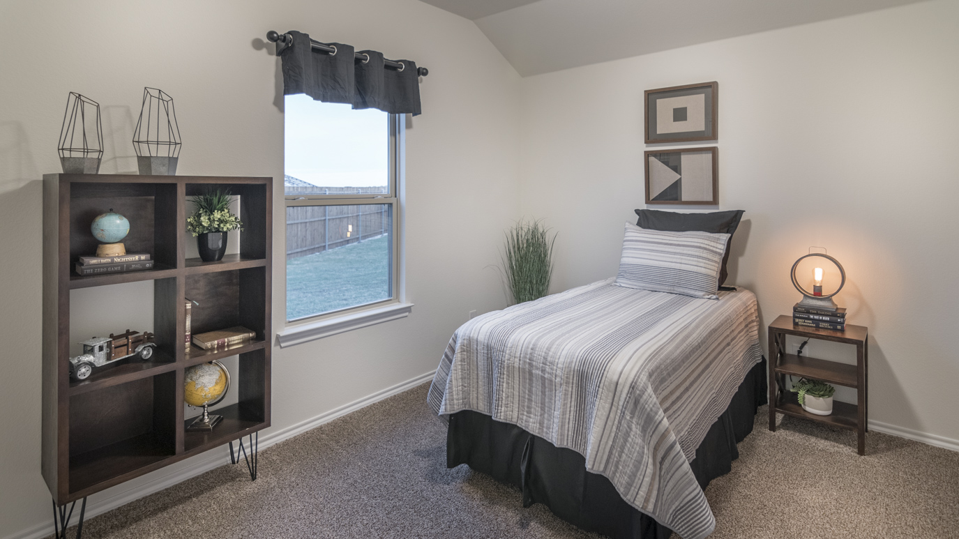 Bedroom 2 with light brown carpets and natural lighting