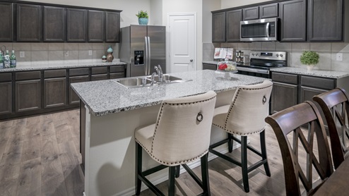 2232 kitchen area with granite countertops and dark cabinets