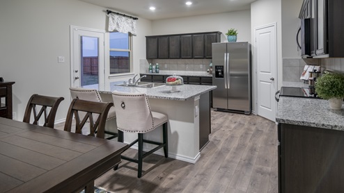 2232 kitchen area with granite countertops and dark cabinets