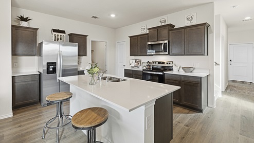 2015 Wildcat Trail model home at Wildcat Ranch in Crandall, TX kitchen with view of entry