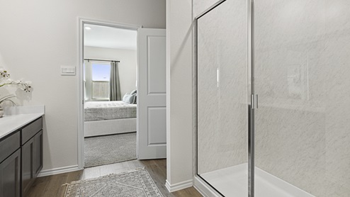 2015 Wildcat Trail model home at Wildcat Ranch in Crandall, TX primary bathroom with hardwood flooring