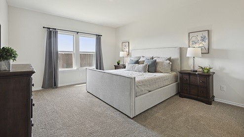 2015 Wildcat Trail model home at Wildcat Ranch in Crandall, TX primary bedroom with large windows