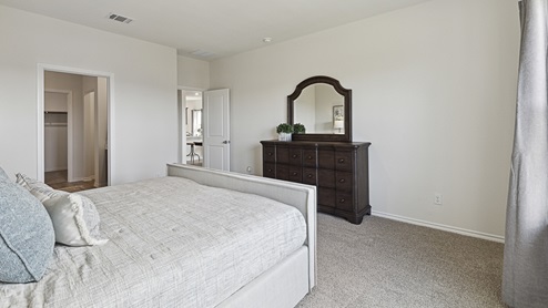 2015 Wildcat Trail model home at Wildcat Ranch in Crandall, TX primary bedroom with large windows