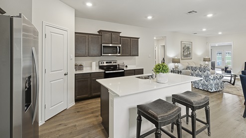 Model home - 2017 Wildcat Trail at Wildcat Ranch in Crandall, TX kitchen with dark cabinets