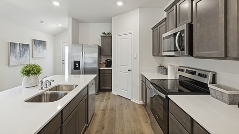 Model home - 2017 Wildcat Trail at Wildcat Ranch in Crandall, TX kitchen area behind the island