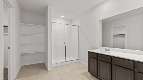 X30E primary bathroom with dark cabinets and tile