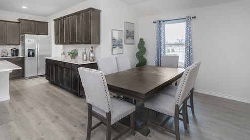 Dining area with window and open concept view into kitchen