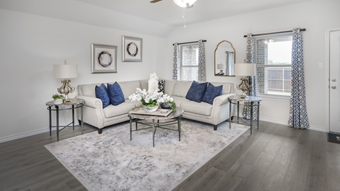 Large living area with two windows and beautiful furnishings
