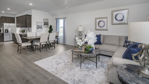 Large living area with two windows and beautiful furnishings