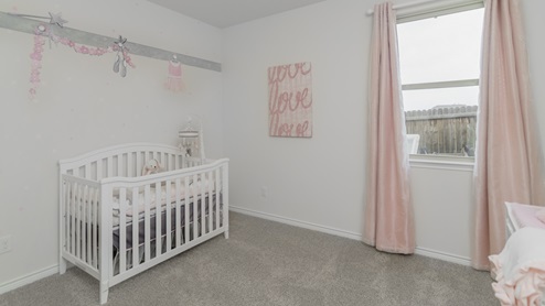 Bedroom with baby crib and a window